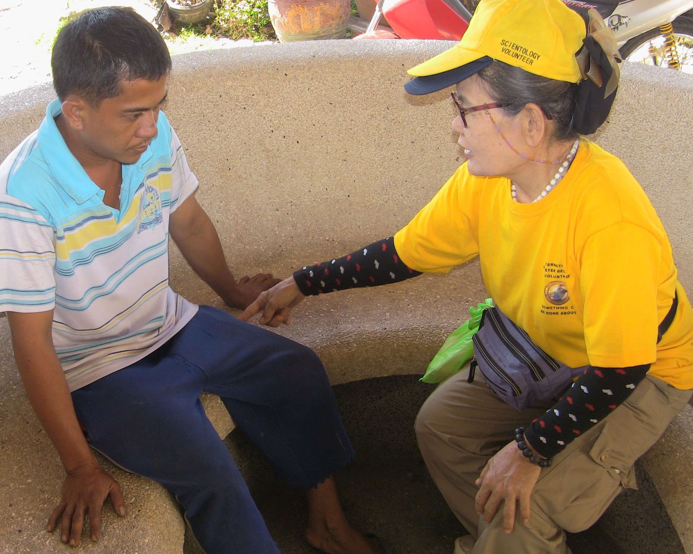 Scientology Volunteer Minister provides a Scientology assist to a young man in the city of Tacloban in the Philippines. Assists are techniques developed by L. Ron Hubbard that help the individual recover more rapidly from the emotional and spiritual effects of loss, stress and trauma.