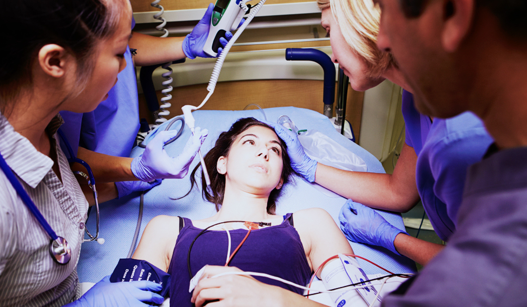 Woman on a gurney surrounded by medical staff