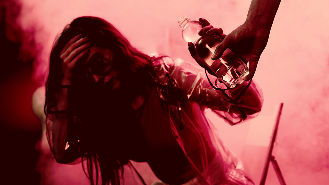 Girl at a party grabbing a bottle of water