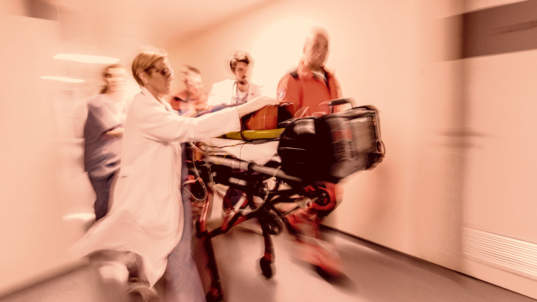 Blurred image of medical staff with a gurney on the way to an emergency room
