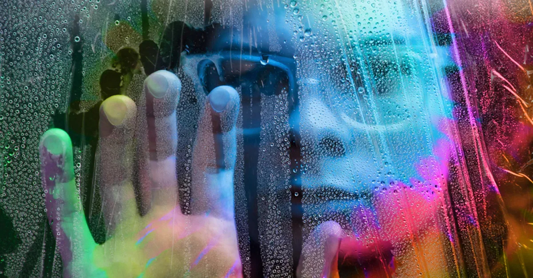 Person looking through glass, abnormal colors and hues in glass