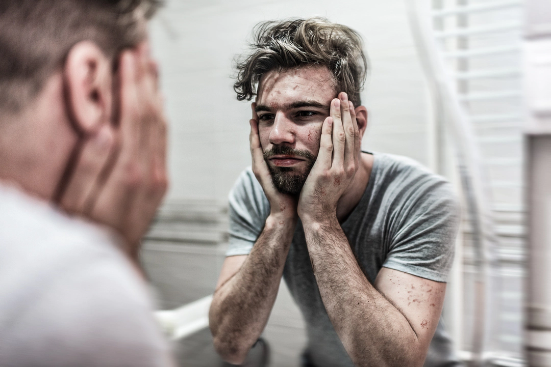 Man's looking in the mirror
