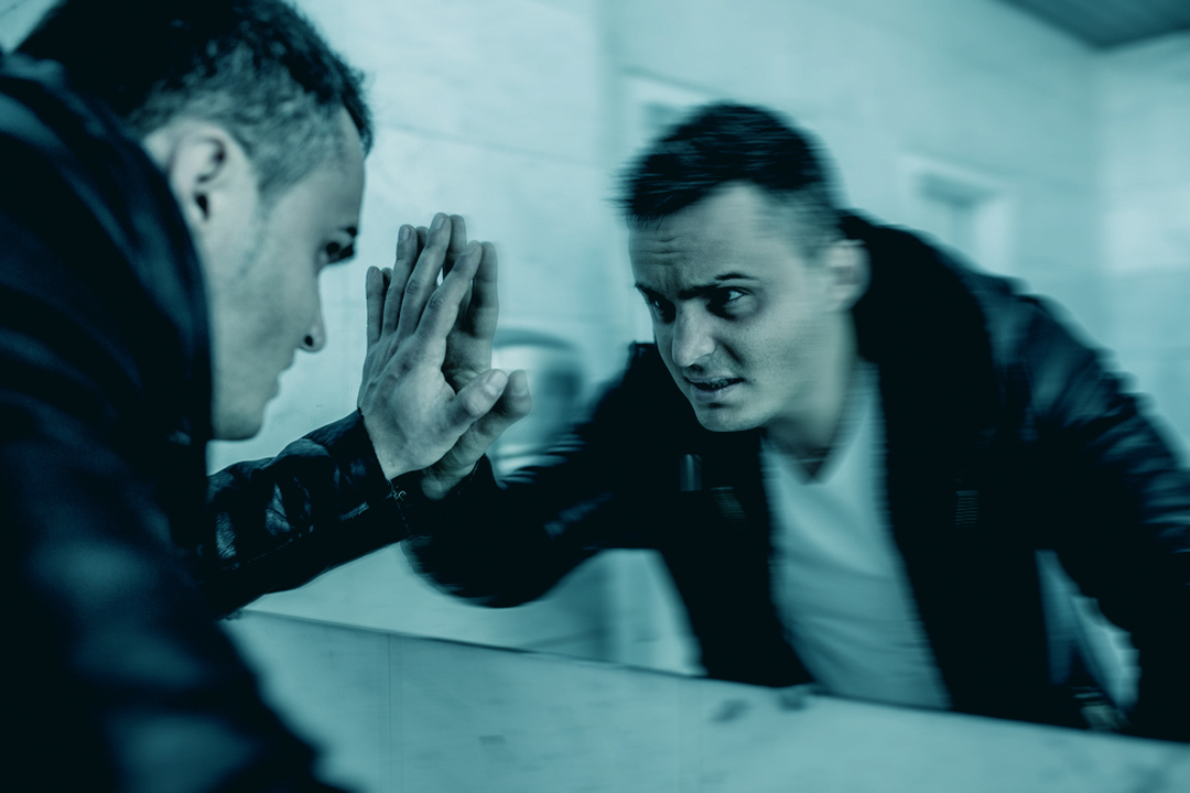 Cocaine addict reflected in a mirror blurred