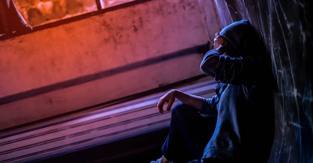 Person sitting with hoodie on, dutched photo