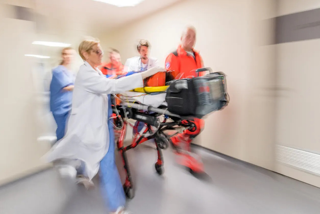 Medical staff rushing a patient on a gurney