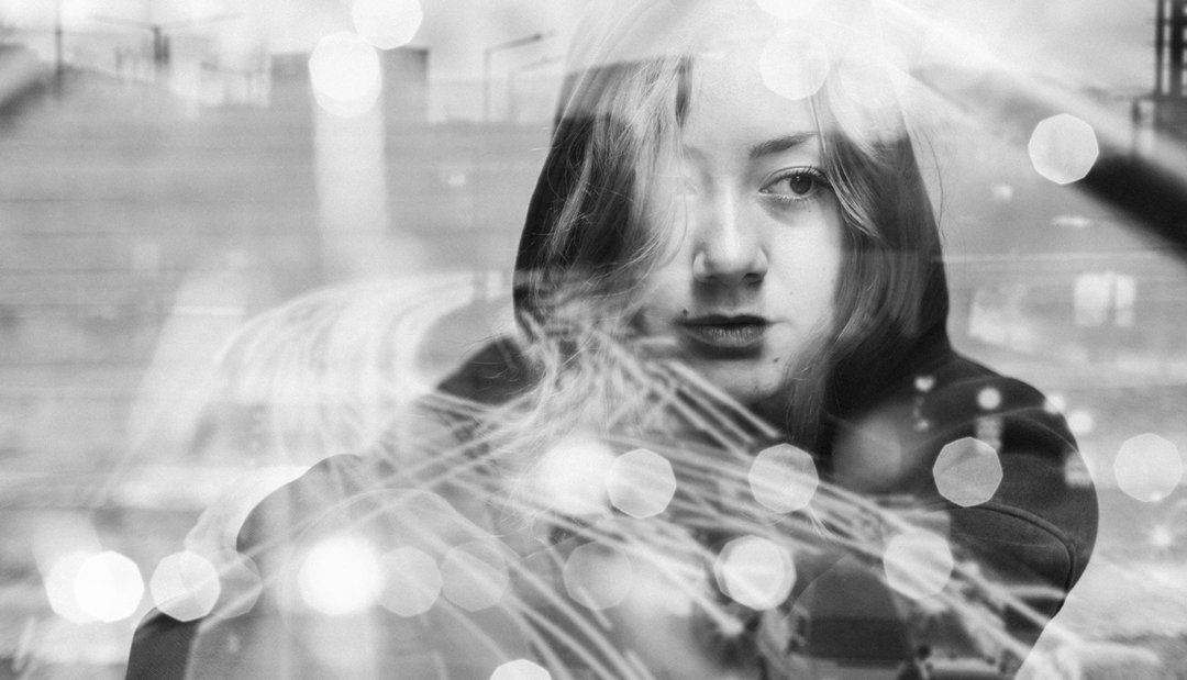 Black and White Image of a Girl reflected in window