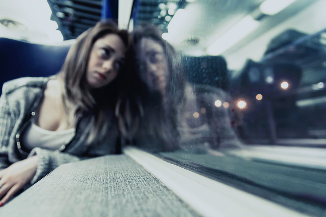 Young woman watching a window - depressed