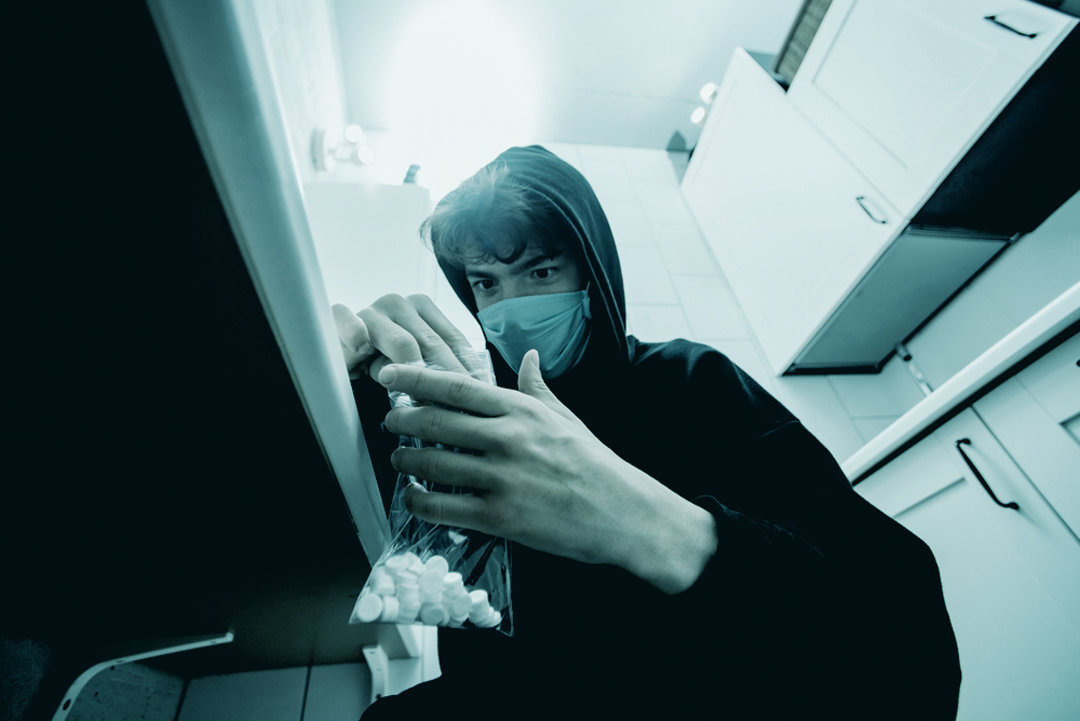 Teenager in kitchen with valium