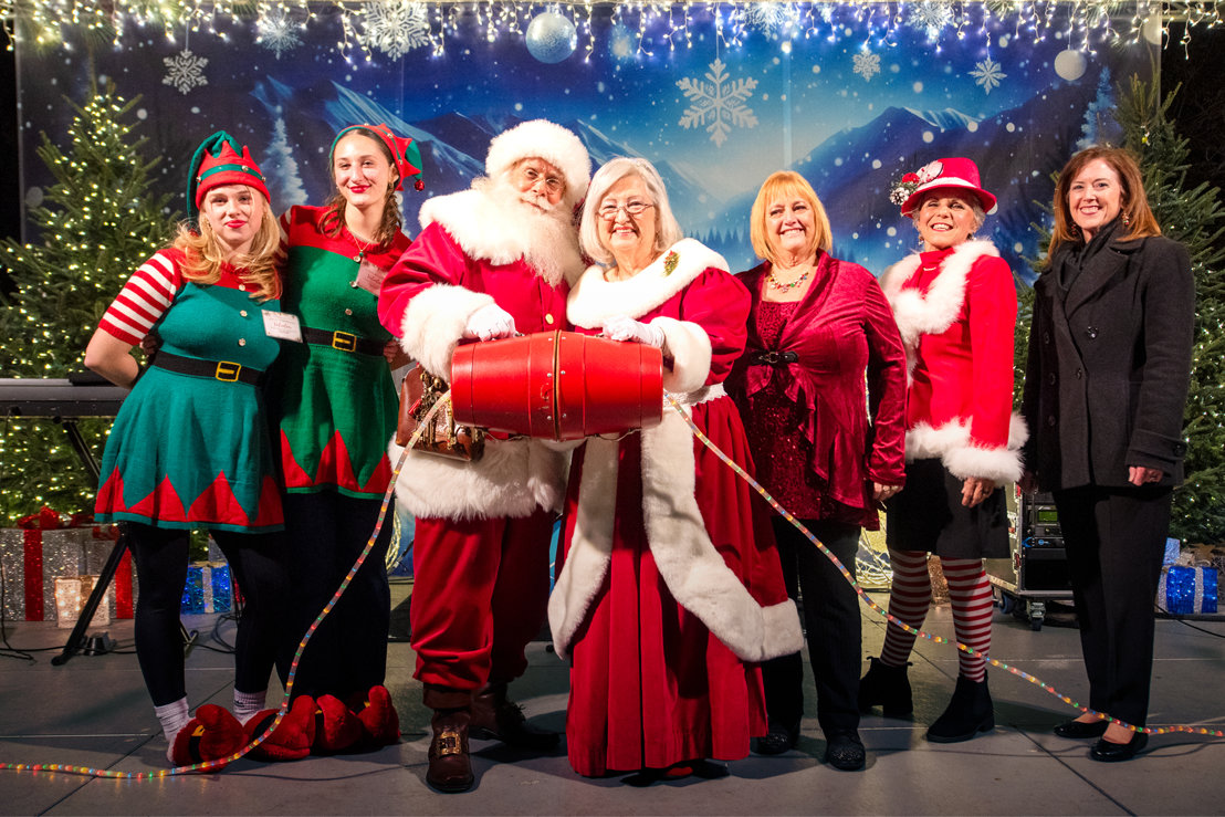 Santa and Mrs. Claus on stage with others