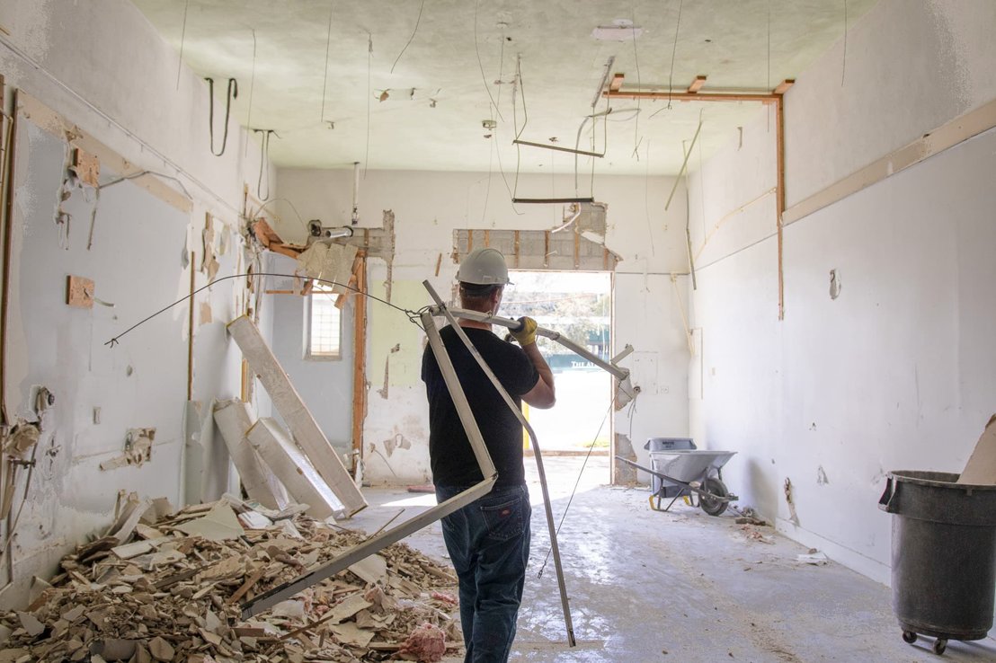 Metal framing is removed during interior cleanup.