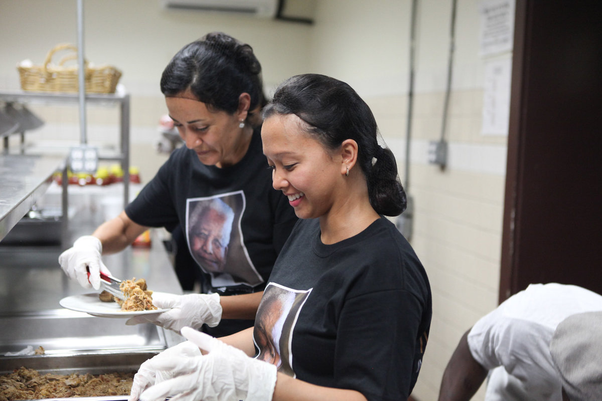 Two women serving soup