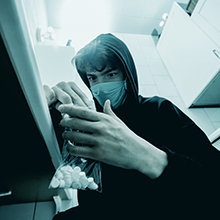 Teenager in kitchen with valium pills