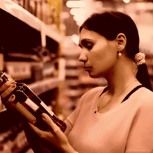 Woman buying alcohol at a super market