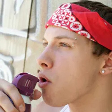 Young adult inhaling