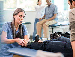 Physical therapist assisting with pain relief