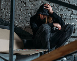 An drug user looking at syringes
