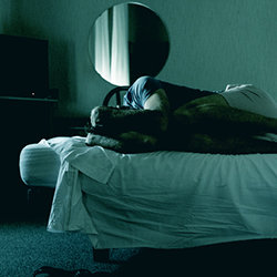 Withdrawal from morphine man rolled up in bed
