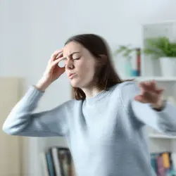 Dizzy woman holding her head