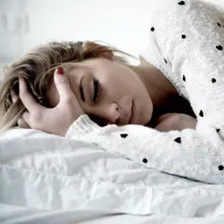 A Teenager feeling sick in bed