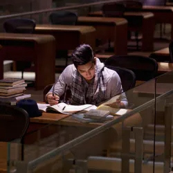 A person in a library studying late