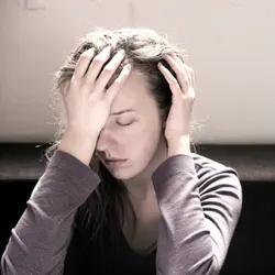 Woman in pain with her eyes closed