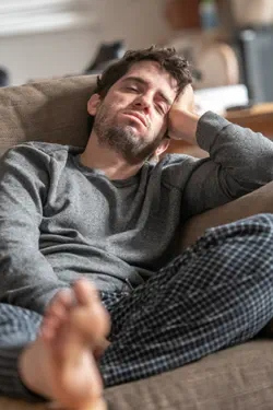 Unkept man on his couch