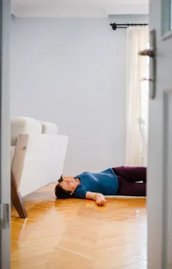 Woman lying on her floor looks like she is passed-out or unconcious