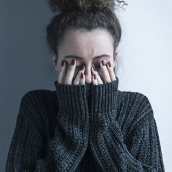 Woman covering her face