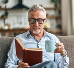 Man enjoying a book and a coffee