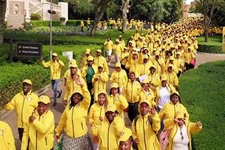 a sea of yellow fills the campus of castle kyami