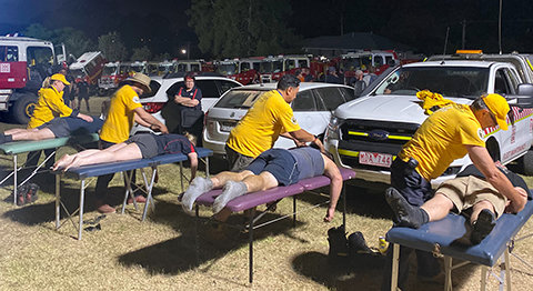 Firefighters receive much-needed assists after returning from an exhausting day of battling fires.