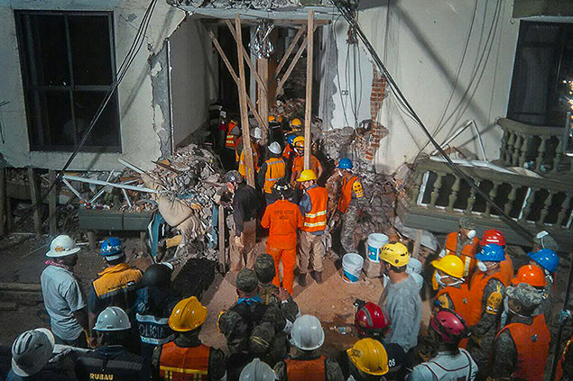 In 20 seconds, a series of major quakes breaks buildings, makes thousands homeless and puts VMs into the field with Los Topos search and rescue, here rescuing a little girl.