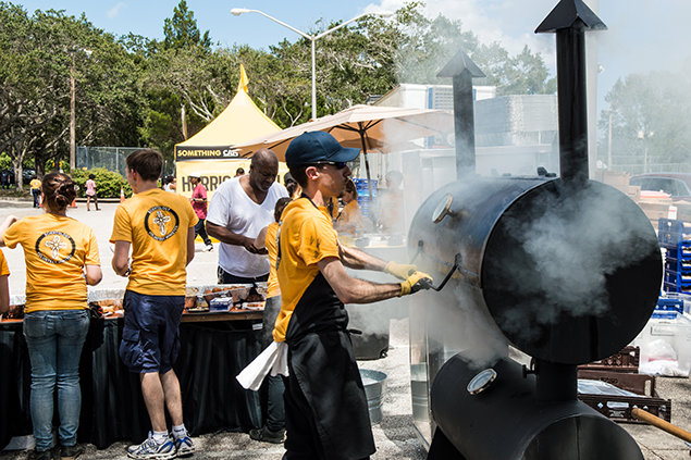 Residents of North Greenwood are served a complimentary barbeque