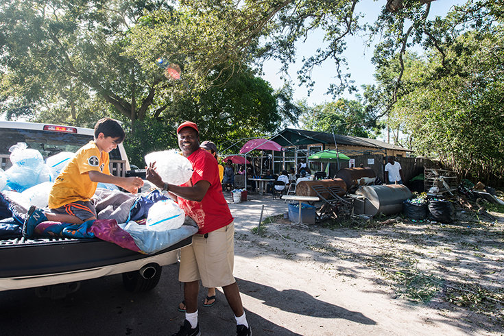 Neighbor to neighbor. Scientology Volunteer Ministers help deliver much-needed ice to North Greenwood residents