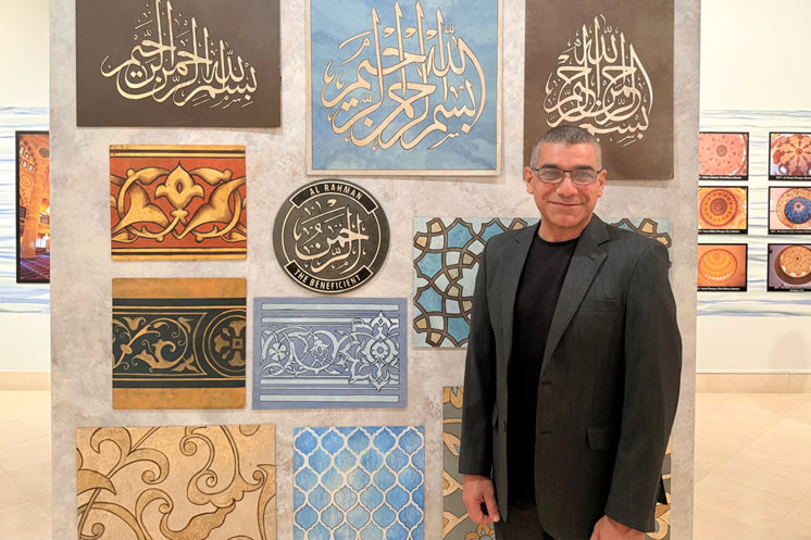 Haroutioun Isack Bastajian standing with his art at the museum