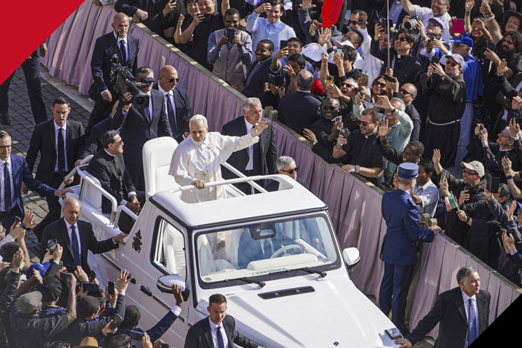 Pope in popemobile surrounded by crwod