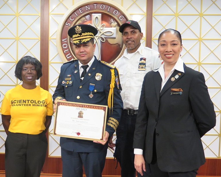 Mr. Juan Gutierrez. Executive Director of La Academia Mundial Bomberos (World Academy of Firefighters) is presented the Community Leadership Award by the Church of Scientology Harlem.