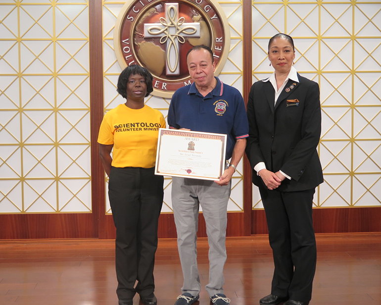 Mr. Israel Miranda of the New York City Emergency Medical Service is presented the Community Leadership Award by the Church of Scientology Harlem.