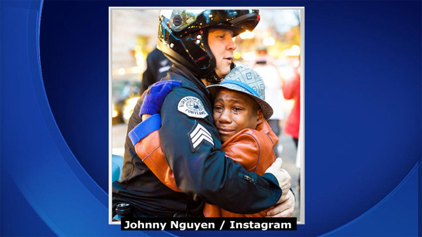 Black boy hugging white officer