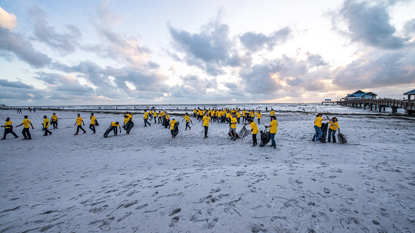 Volunteer Ministers walking into the beach