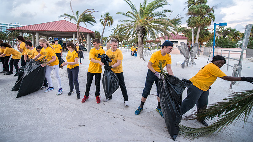 Volunteer Ministers walking into the beach