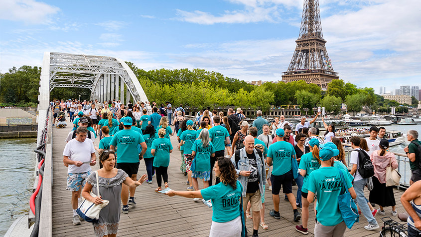 Volunteers distributing drug prevention booklets by the Eiffel Tower in Paris.