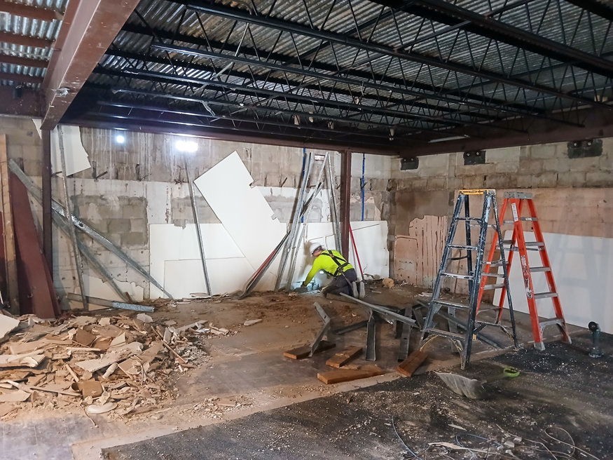 Studs are removed to reveal the original framework at the former Vaporium site.