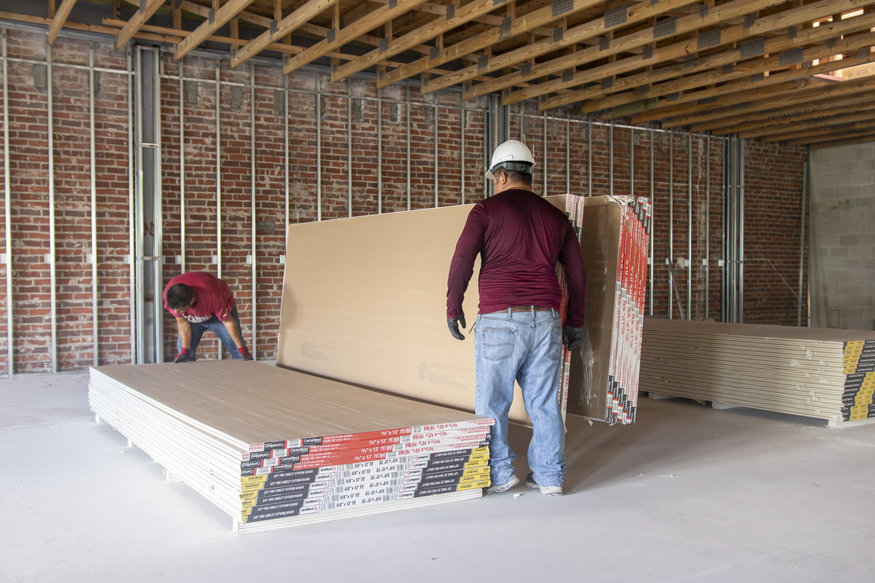 Drywall staged for installation on second floor.