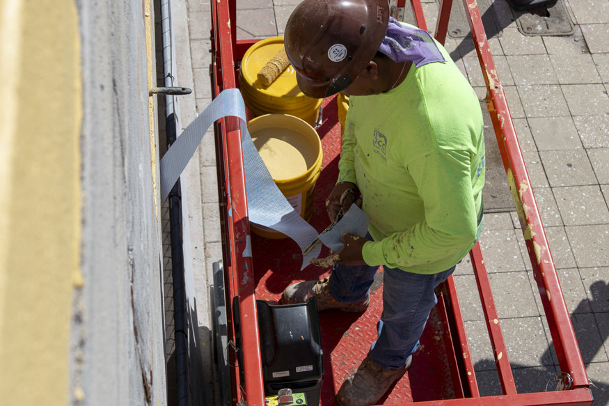 Close-up of mesh and primer on window opening.