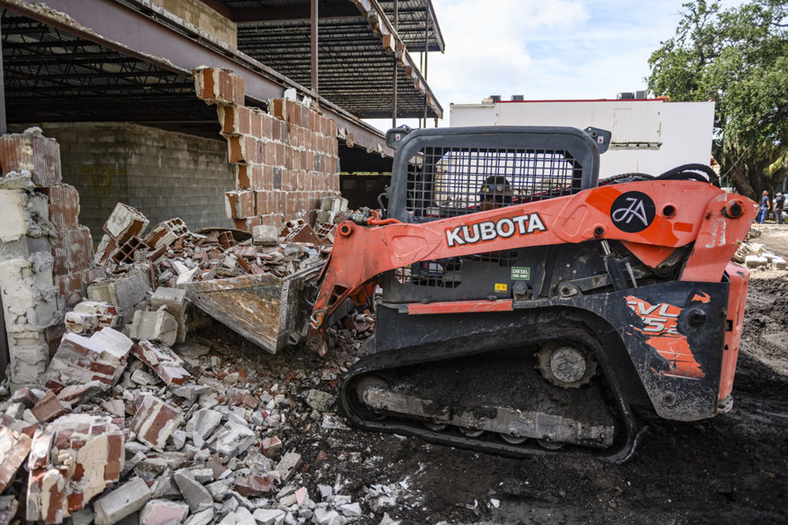Heavy equipment clearing demolition debris.
