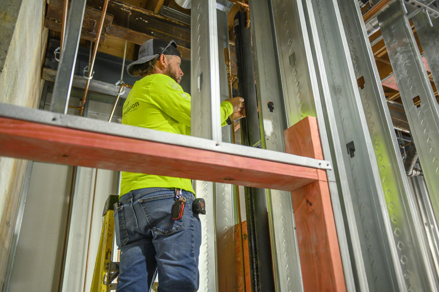 Insulation is adjusted and fitted closely around piping to ensure a snug seal.