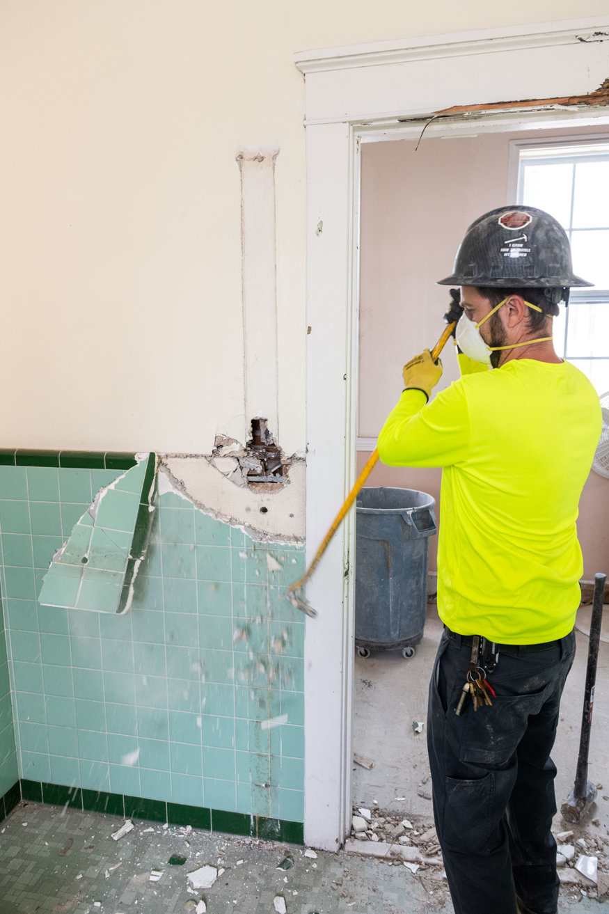 Tile removal near doorway in restroom. 