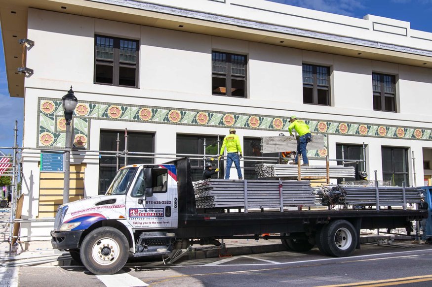 Workers loading scaffolding materials onto truck at Peoples Bank.