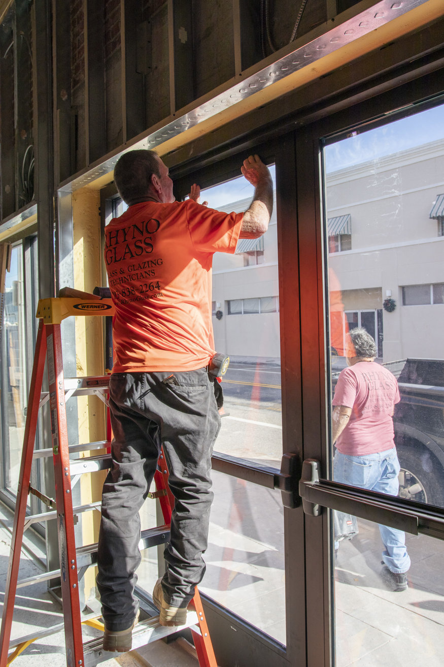 Tinted glass in storefront doors.